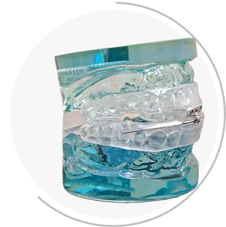 Teeth appliance in bluish green and transparent with white round background